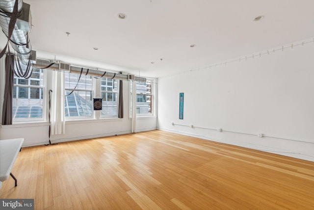 spare room with wood finished floors and baseboards