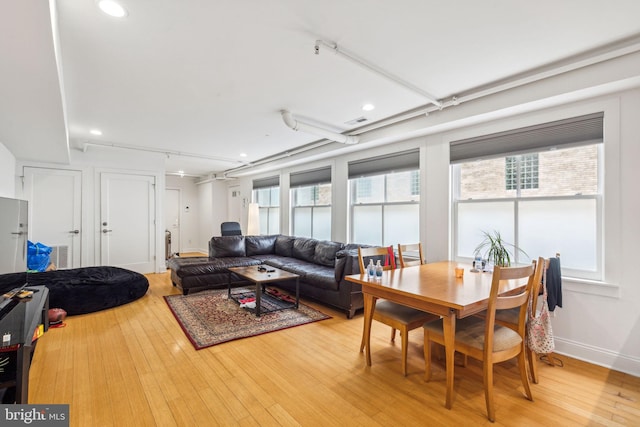 living room with light wood-style flooring, recessed lighting, baseboards, visible vents, and track lighting