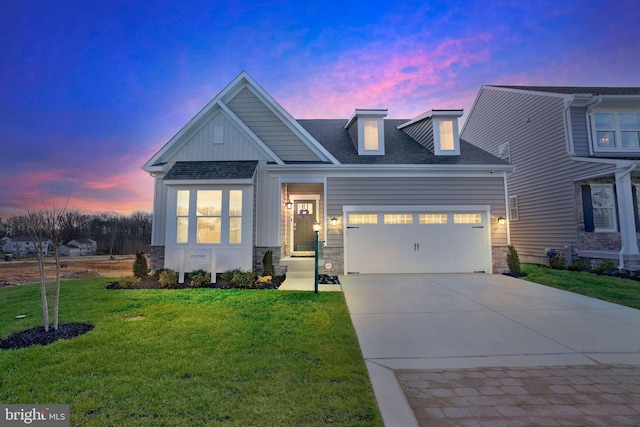 view of front of property with a yard and a garage