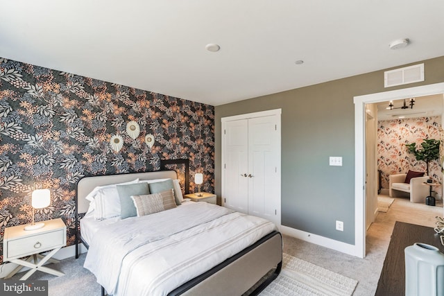 carpeted bedroom with a closet