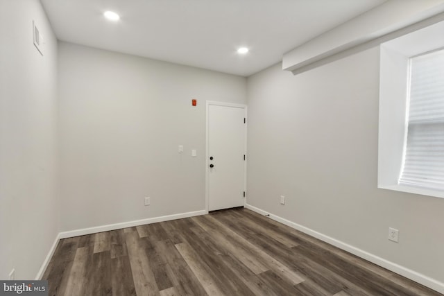 spare room with dark hardwood / wood-style floors