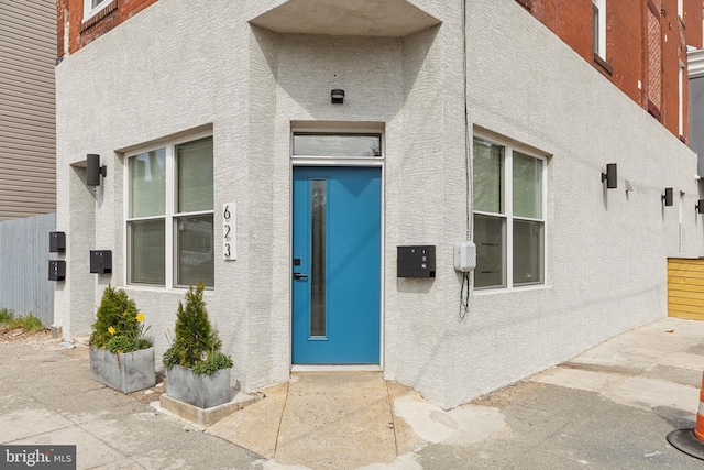 property entrance featuring a patio area