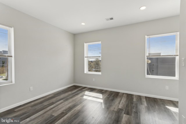 spare room with dark wood-type flooring