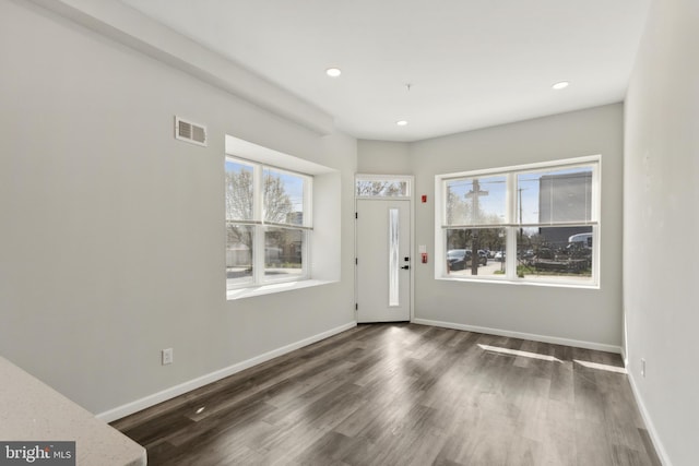 entryway with dark hardwood / wood-style flooring