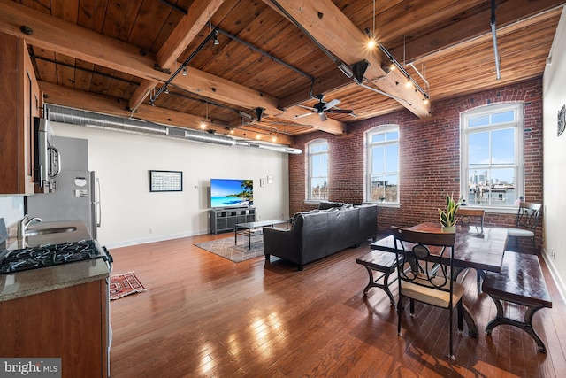 living room featuring brick wall, wood ceiling, hardwood / wood-style floors, rail lighting, and ceiling fan