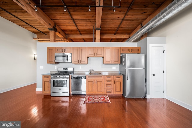 kitchen featuring stainless steel appliances, beam ceiling, dark hardwood / wood-style flooring, wooden ceiling, and sink