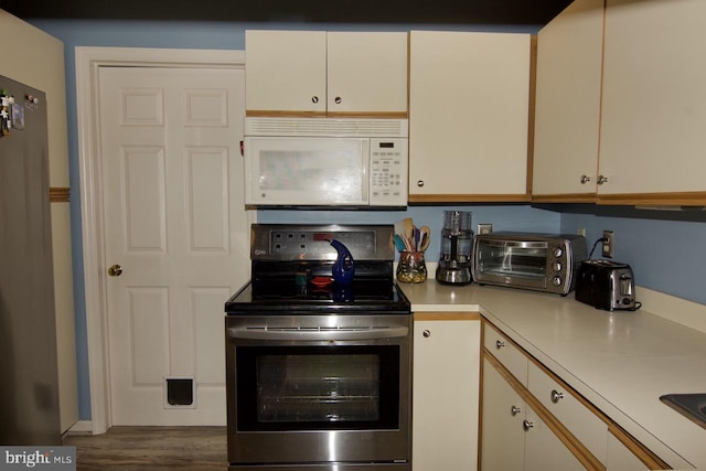 kitchen with wood-type flooring and appliances with stainless steel finishes