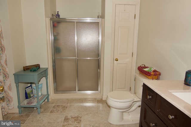 bathroom with vanity, toilet, and an enclosed shower