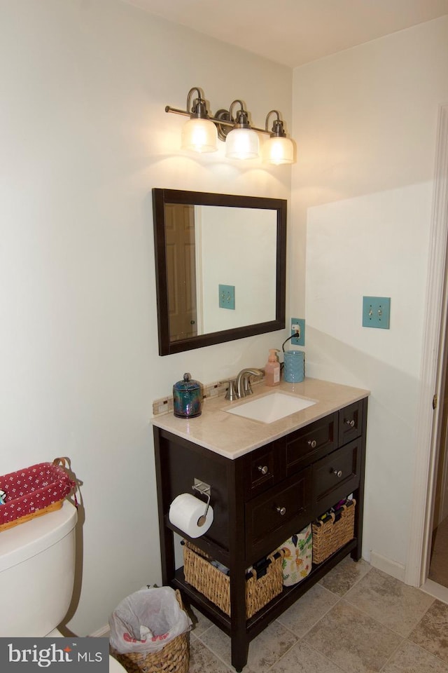 bathroom featuring vanity, tile patterned flooring, and toilet