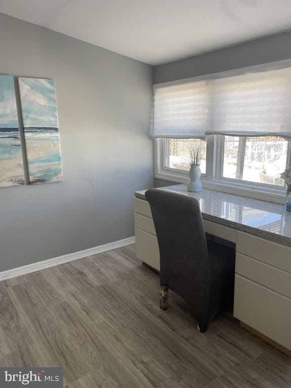 office space featuring built in desk and hardwood / wood-style floors