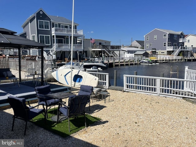 view of patio / terrace featuring a boat dock and a water view