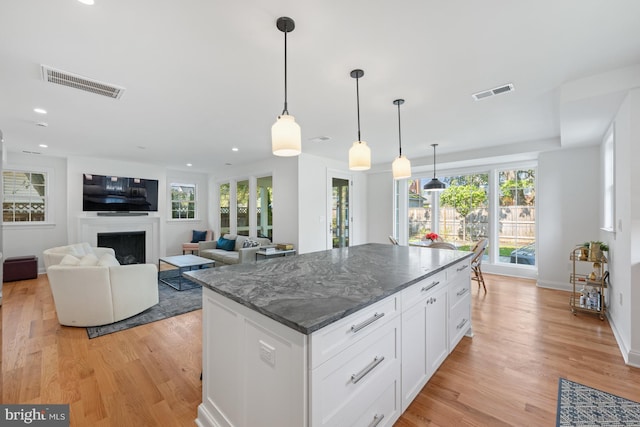 1307 Cleveland St, Alexandria, VA 22302 - kitchen with light wood-type flooring, healthy amount of natural light, a fireplace, and recessed lighting