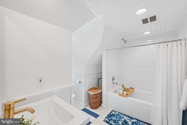 1307 Cleveland St, Alexandria, VA 22302 - full bath with wainscoting, shower / bath combination with curtain, and marble look tile flooring