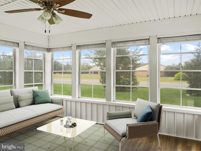 sunroom with ceiling fan and wooden ceiling