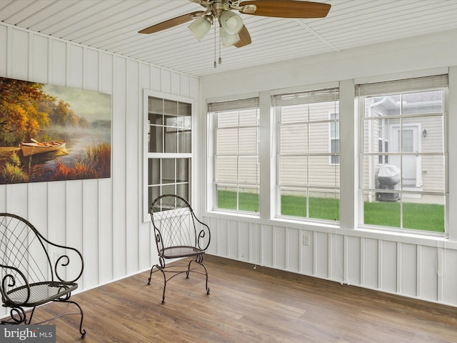 sunroom featuring ceiling fan and plenty of natural light