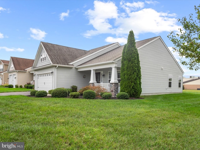 view of front facade featuring a front lawn, a garage, and covered porch