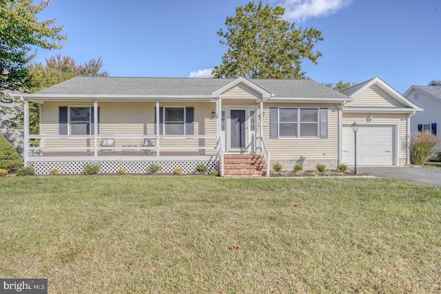 ranch-style house with covered porch, a front yard, and a garage