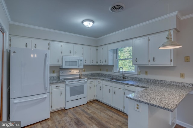 kitchen with white appliances, hanging light fixtures, white cabinets, and light hardwood / wood-style flooring