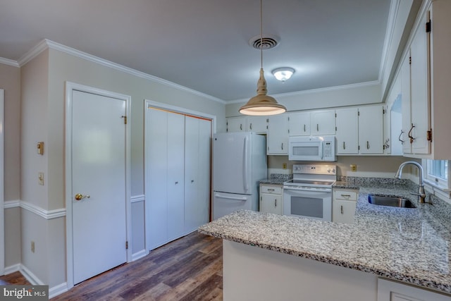 kitchen with white appliances, sink, dark wood-type flooring, pendant lighting, and white cabinetry