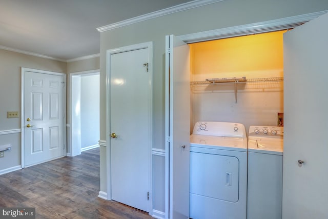 washroom with crown molding, washer and clothes dryer, and dark hardwood / wood-style floors