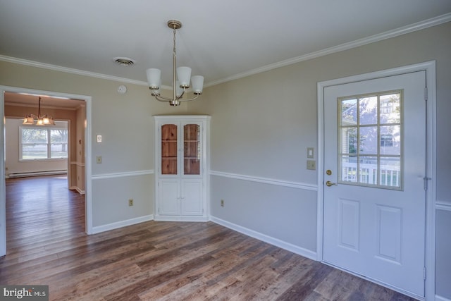 unfurnished dining area featuring plenty of natural light, dark wood-type flooring, and a chandelier