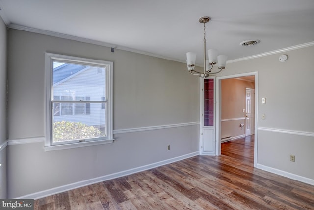 spare room with ornamental molding, a chandelier, hardwood / wood-style floors, and a baseboard heating unit