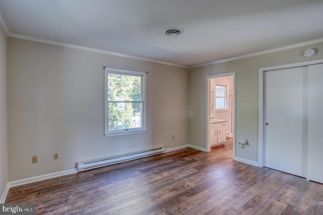 unfurnished bedroom with a closet, hardwood / wood-style flooring, ornamental molding, ensuite bathroom, and a baseboard radiator