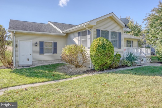 single story home featuring a deck and a front yard