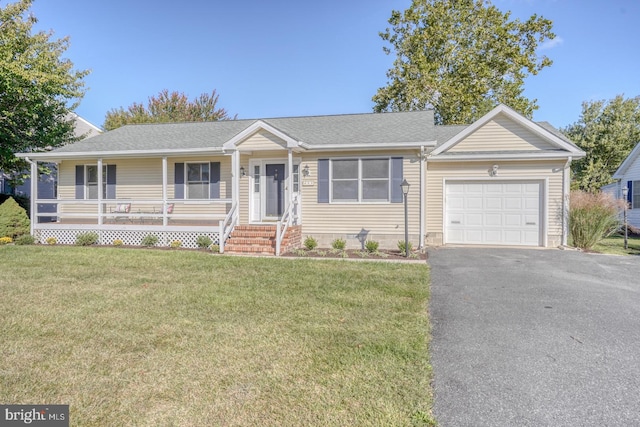 ranch-style home featuring a garage, a front lawn, and covered porch