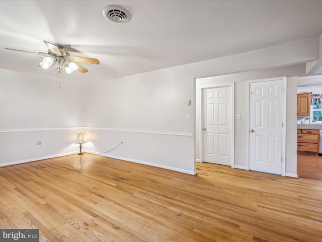 empty room featuring ceiling fan and light wood-type flooring