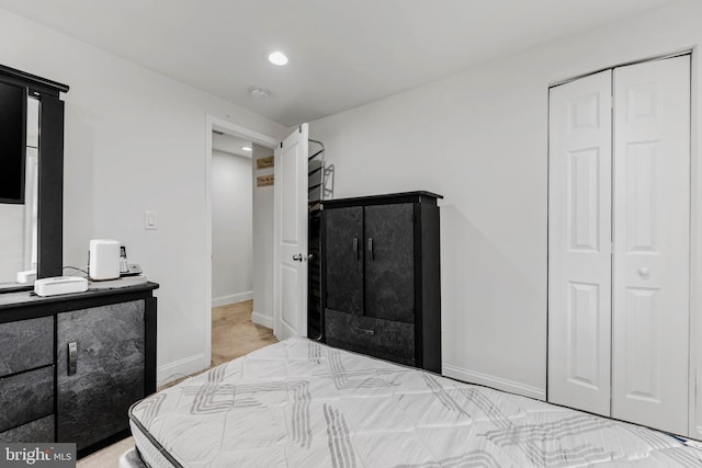 bedroom with a closet and light colored carpet