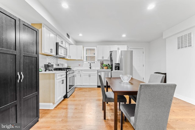 4201 Morrison Ct, Baltimore City, MD 21226 - kitchen with light wood-style flooring, light countertops, white cabinets, visible vents, and appliances with stainless steel finishes