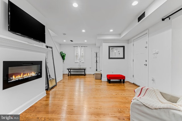 4201 Morrison Ct, Baltimore City, MD 21226 - living room with a glass covered fireplace, recessed lighting, light wood finished floors, and baseboards