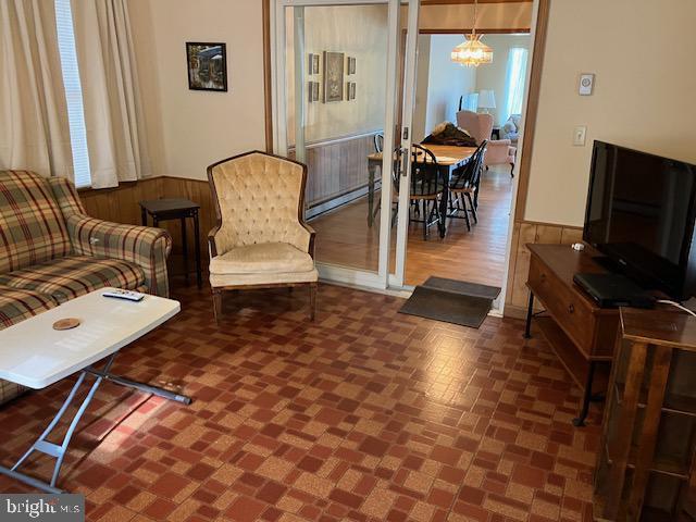 living room featuring a notable chandelier and a baseboard radiator