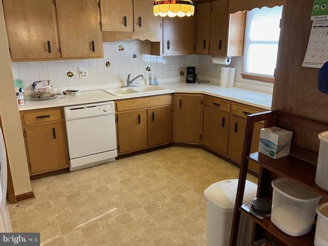 kitchen with sink, backsplash, and white dishwasher