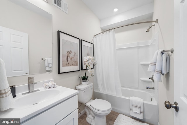 full bathroom featuring shower / bathtub combination with curtain, hardwood / wood-style flooring, vanity, and toilet