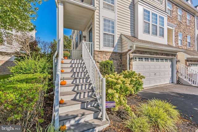 doorway to property with a garage