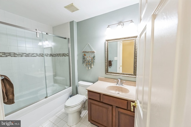 full bathroom featuring enclosed tub / shower combo, vanity, tile patterned flooring, and toilet