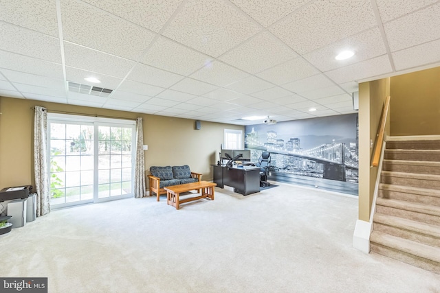 sitting room with a paneled ceiling and carpet