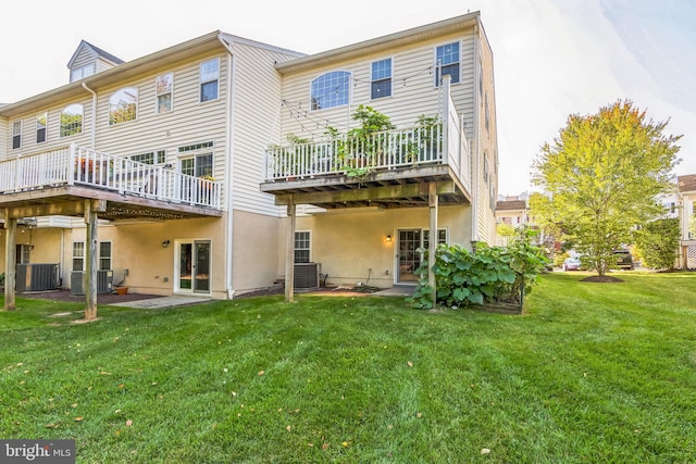 back of property featuring a deck, a yard, and central air condition unit