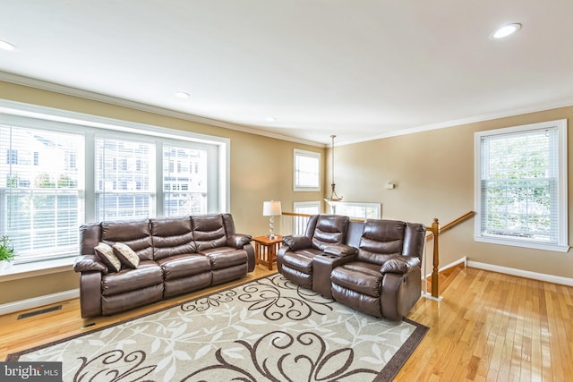 living room featuring wood-type flooring and ornamental molding