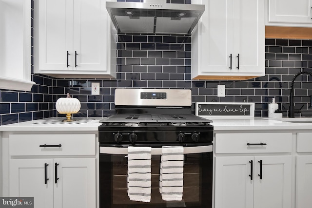 kitchen with gas stove, decorative backsplash, and white cabinetry