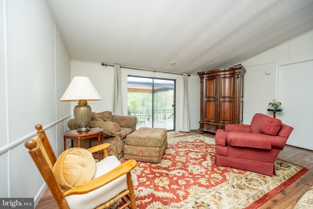 living room featuring light hardwood / wood-style floors and vaulted ceiling