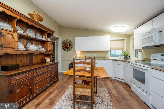 kitchen featuring lofted ceiling, white appliances, white cabinetry, and dark wood-type flooring