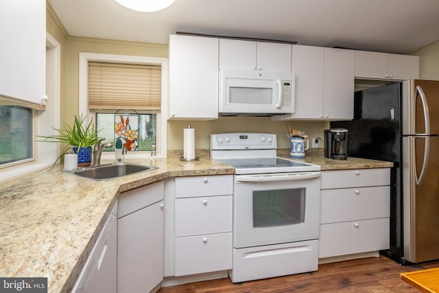 kitchen with white appliances, sink, white cabinets, and dark hardwood / wood-style flooring