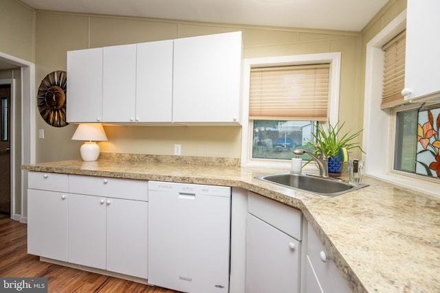 kitchen with white cabinets, dishwasher, vaulted ceiling, and hardwood / wood-style floors