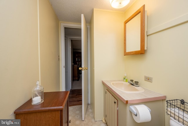 bathroom with a textured ceiling and vanity