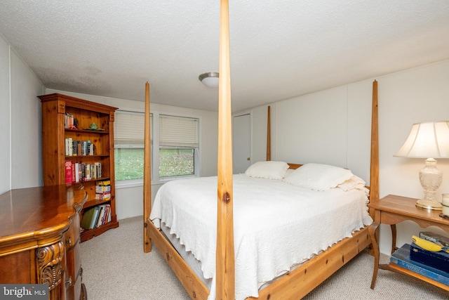 carpeted bedroom with a textured ceiling