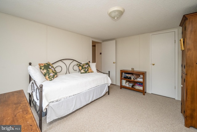 carpeted bedroom with a textured ceiling