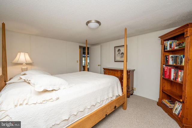 carpeted bedroom featuring a textured ceiling